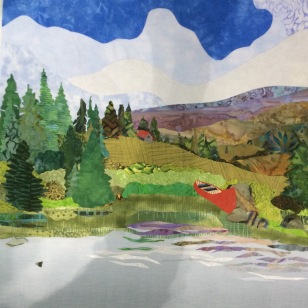 A red canoe was added and to balance it, a little red roofed cabin on the hill. I was not happy with the rock. I had also changed the grasses at the edge of the lake