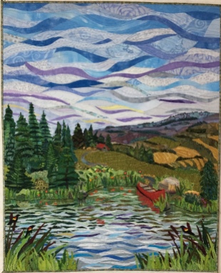 With Sue's critiqque I attempted to gain some atmospheric perspective by making the lower horizon clouds thinner and adding some purple and some yellow in the clouds. In the water I used larger and longer pieces of fabric at the front. More individual grasses were addd around the shoreline for more depth and for more contrast I added yellow hayfields on the right on the roling hills. Finished!